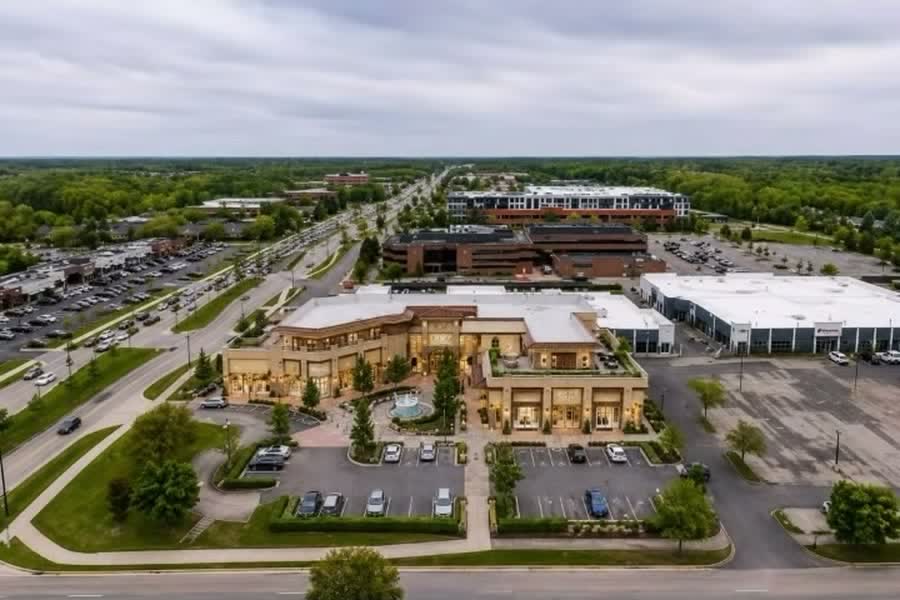 Redevelopment concept: a luxury retail plaza drawn onto the subject site in an aerial view of the Orchard Lake Road corridor.